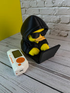 Rubber Hacky Black Hat Operative collectible detail view with Flipper Zero for scale