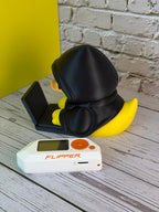 Rubber Hacky Black Hat Operative collectible rear three-quarter view with Flipper Zero for scale