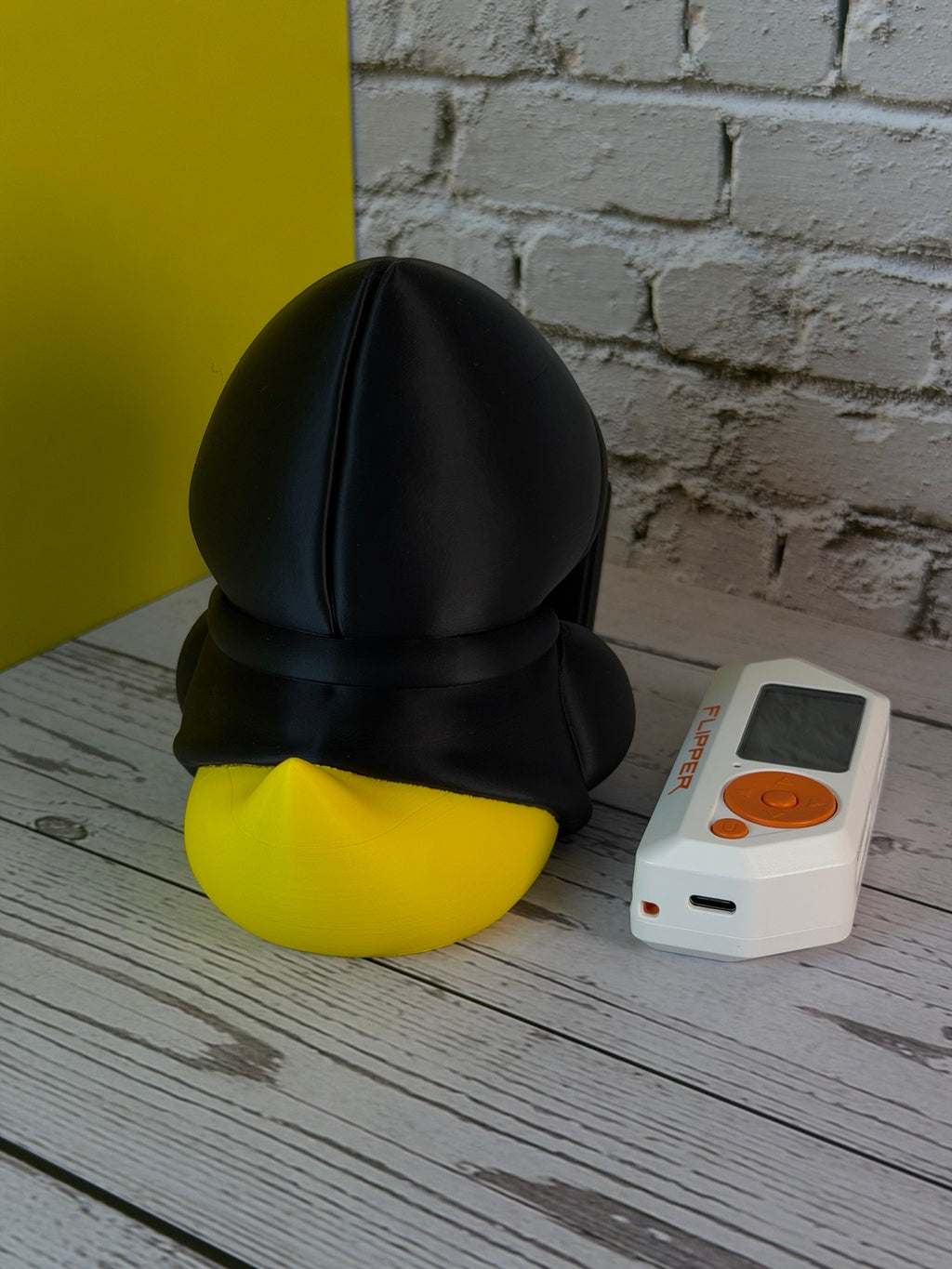 Rubber Hacky Black Hat Operative collectible rear view with Flipper Zero for scale